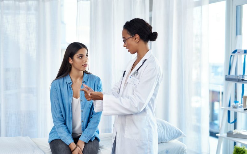 Shot of a young woman having a consultation with her doctor